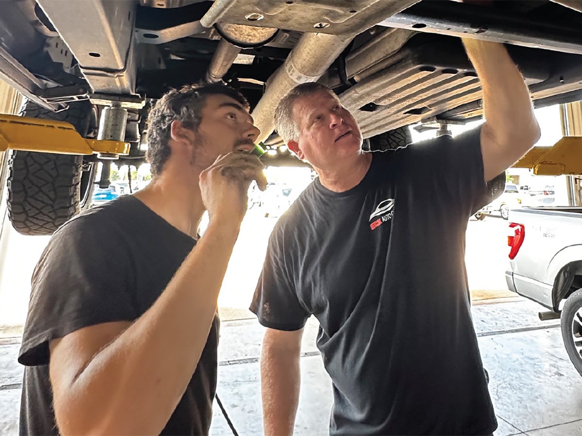 Eck Tech apprentice inspecting a vehicle and learning automotive diagnostics